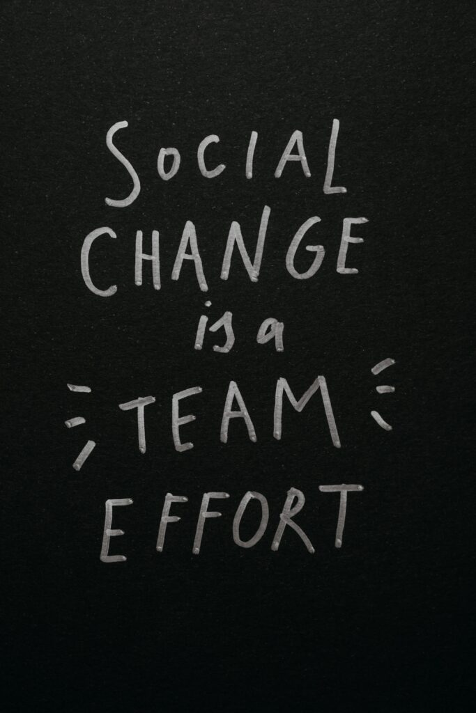 pexels photo 6185549 6185549 Inspirational quote 'Social Change is a Team Effort' on a black background, emphasizing collective action.
